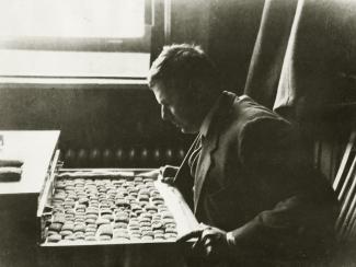 Daniel D. Luckenbill examines cuneiform documents. Mr. Luckenbill, a professor of Assyriology at the University of Chicago, was the first editor of the Chicago Assyrian Dictionary. Photo courtesy of University of Chicago Library, Special Collections Research Center [Image Identifier: apf1-04021].